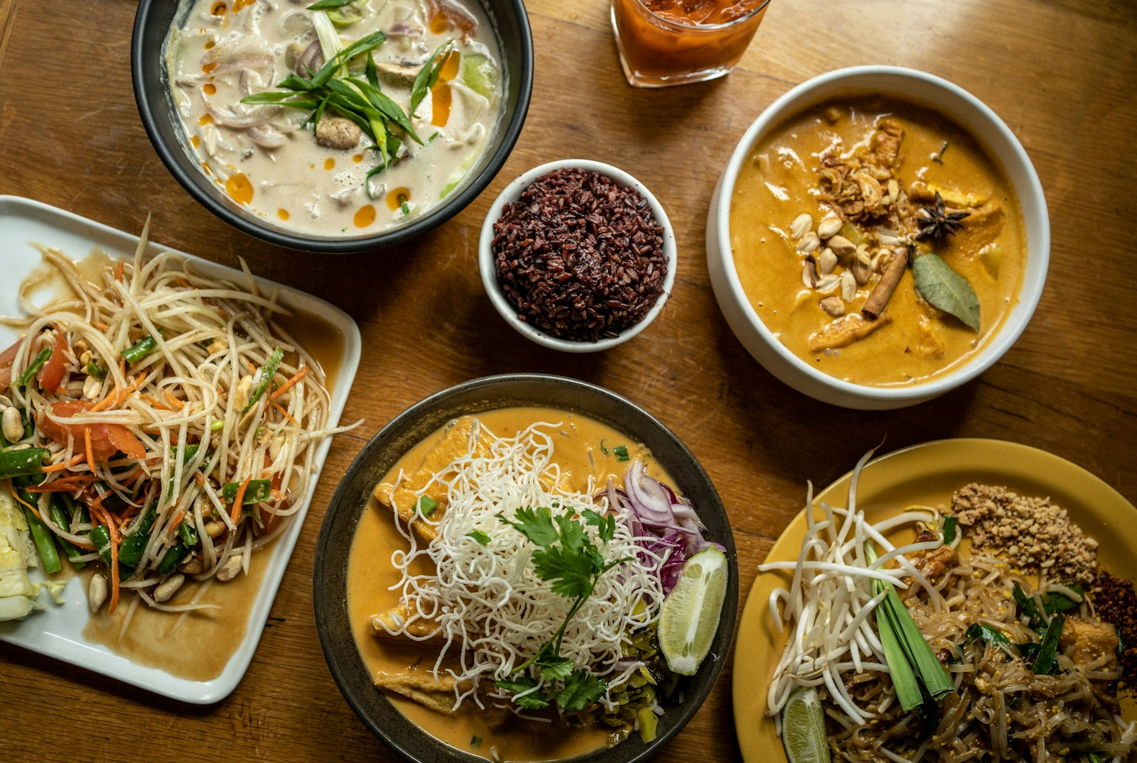 a wooden table topped with plates of food